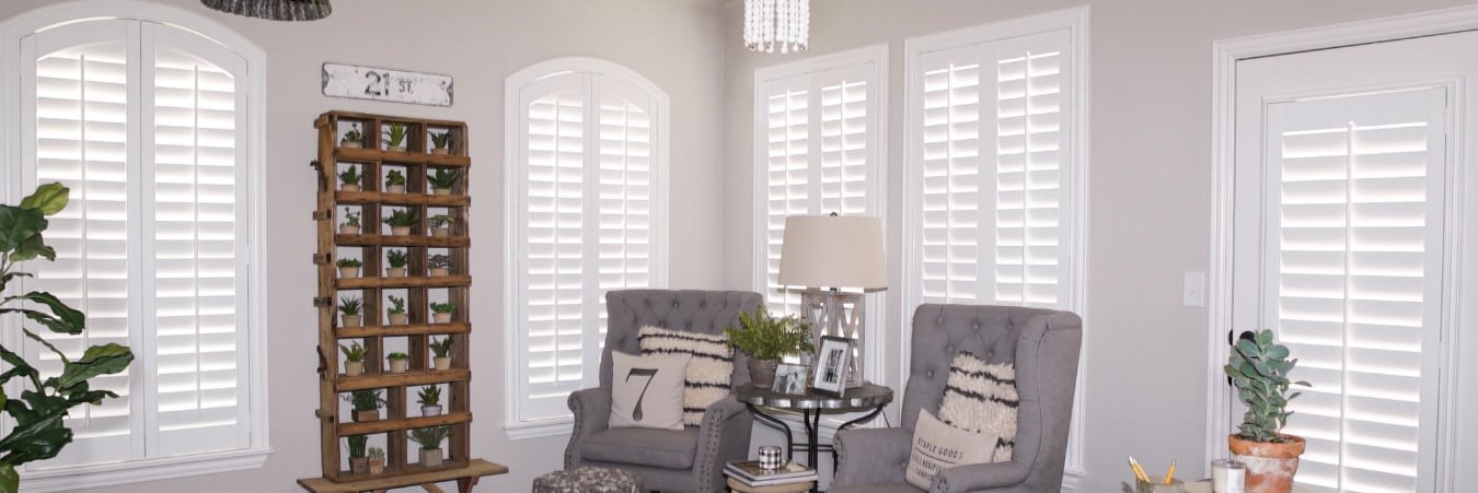Polywood® shutters are attractive from the inside or out. Plantation shutters over a couch